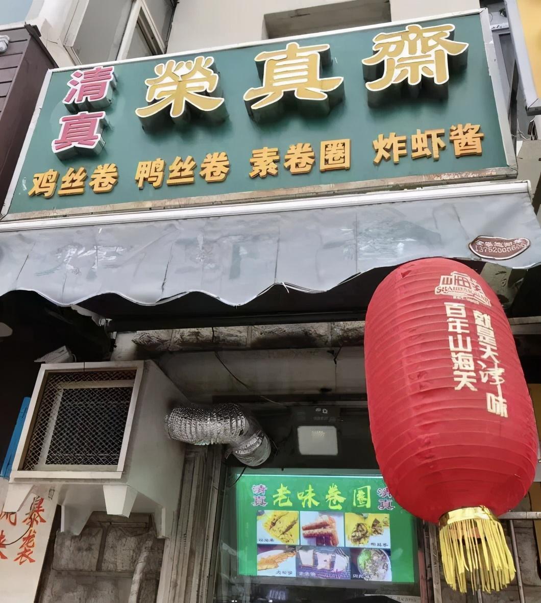 从南丰路右拐,沿着马路牙子往前走,一楼窗口绿底黄字的"荣真斋",招牌