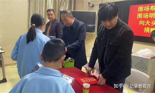 捐赠会现场,王宇洋校长代表大头山学区为围场帮帮团及明亮眼镜店颁发